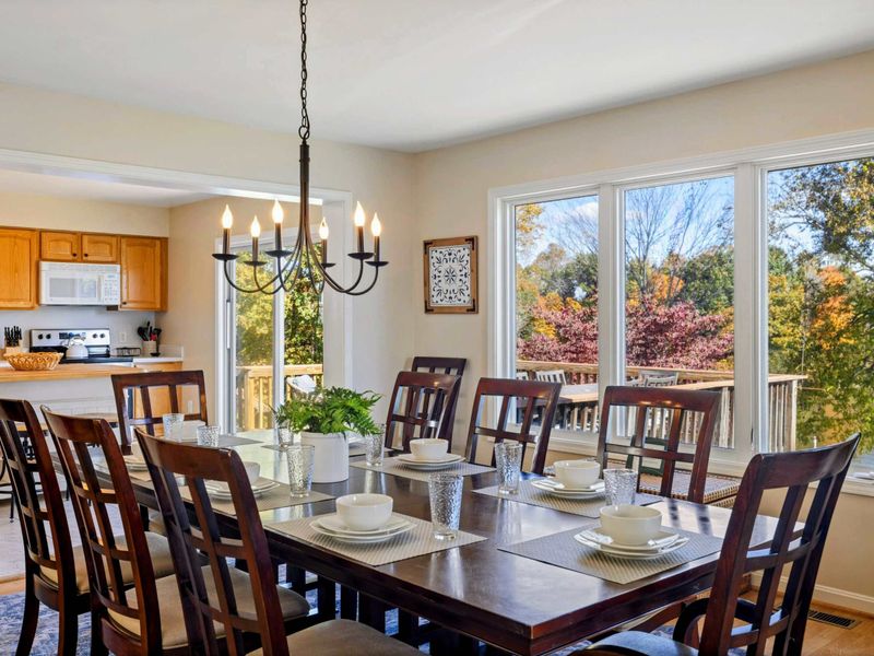 Beautifully set dining table with large windows and a view, seamlessly connected to the kitchen