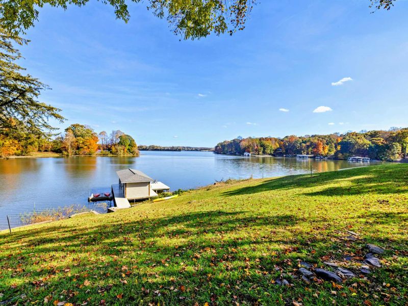 Tranquil lakefront setting with a private dock, ideal for relaxing and enjoying nature