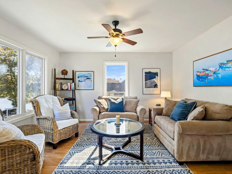 Charming sitting room with cozy seating, tasteful decor, and abundant natural light