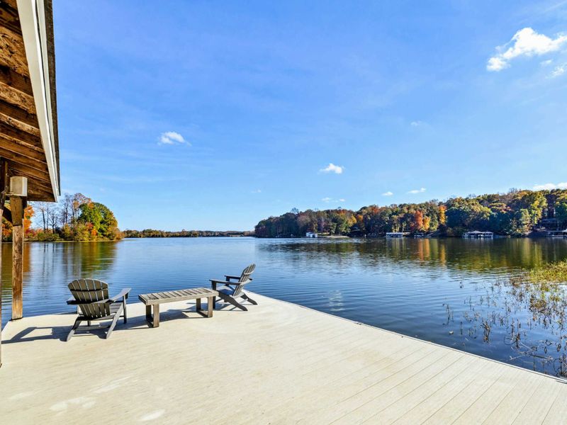 Private lakeside dock with Adirondack chairs, perfect for unwinding and soaking in the serene views
