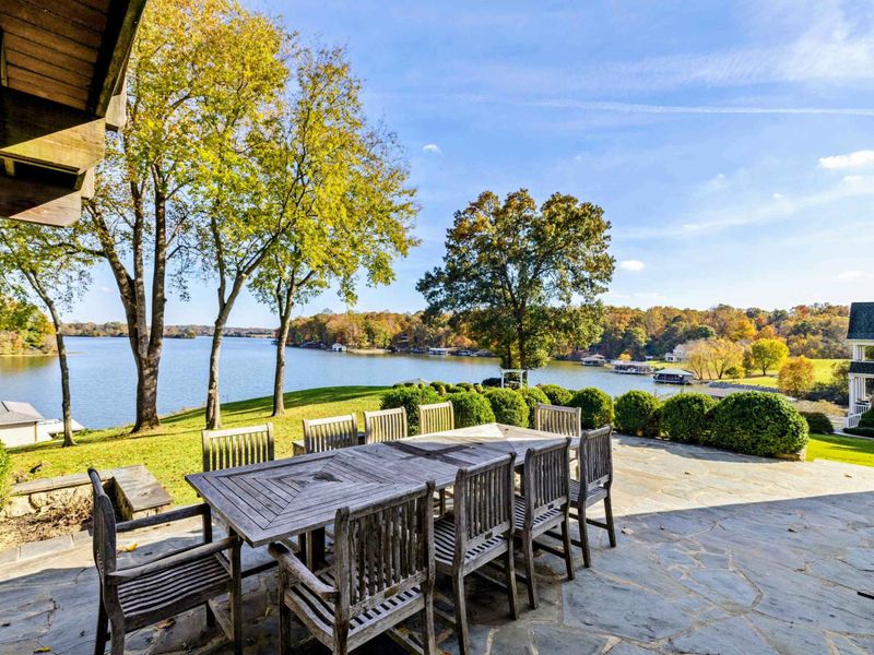 Scenic outdoor dining area with a large table, perfect for gatherings with stunning lake views