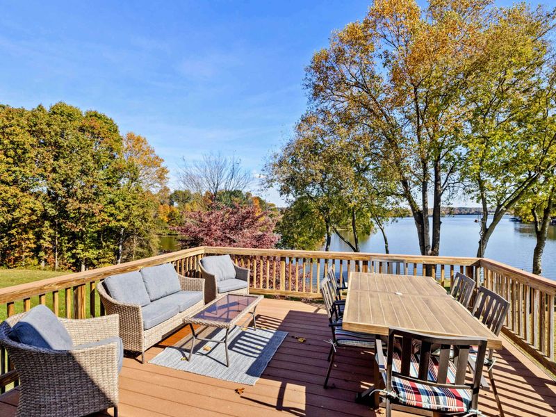 Beautiful deck with comfortable seating and dining area, offering stunning views of the lake
