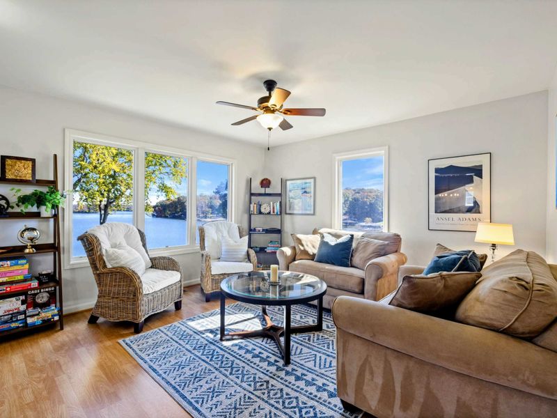 Cozy sitting room with lake views, comfortable seating, and a selection of books and games