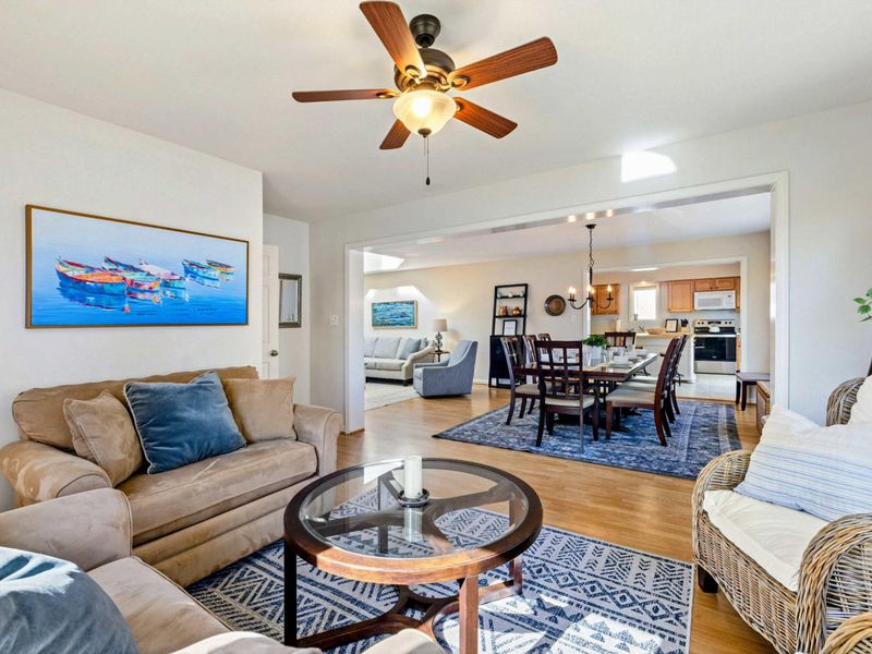 Open and inviting sitting room connected to the dining area, perfect for relaxing and socializing