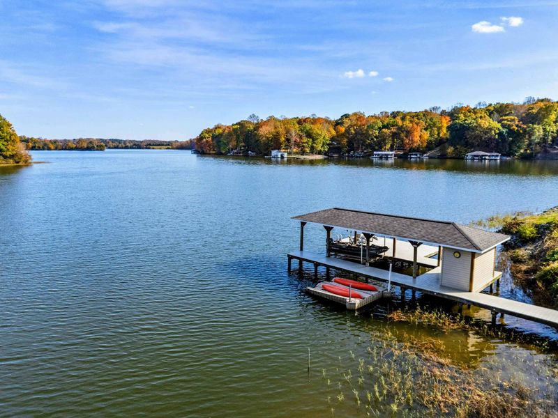 Peaceful lakefront dock with covered storage and kayak access, perfect for water activities and relaxation