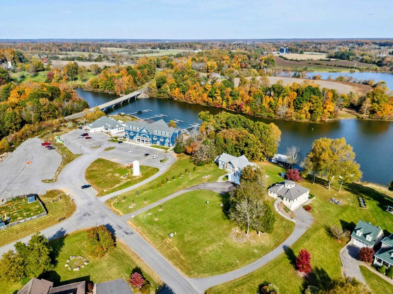 Aerial - Drone view of the Stonewall community area near the Route 208 bridge, marina, and fall foliage along the shoreline.