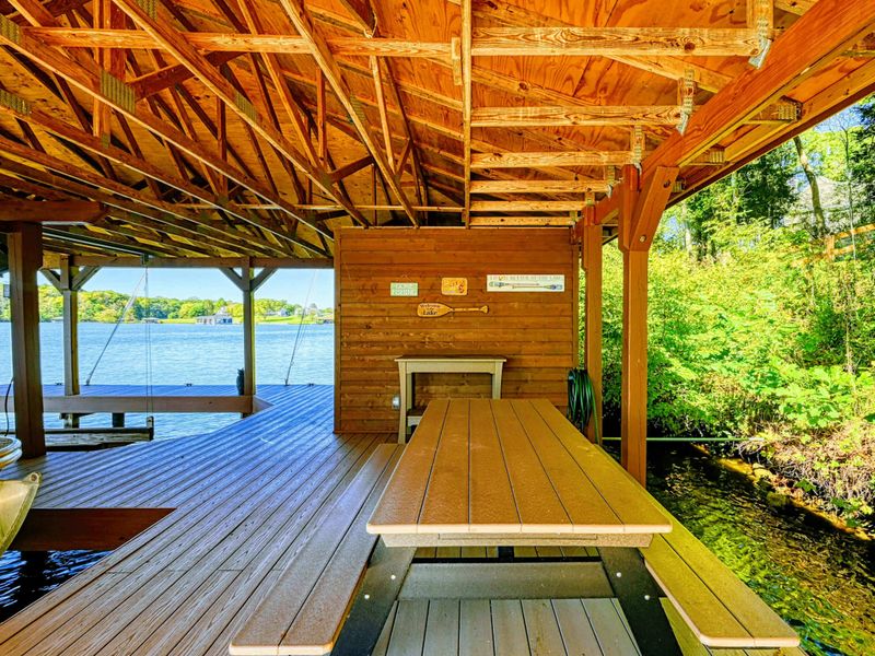 Boathouse - Timber frame covered boathouse shelters the boat and creates a shaded gathering spot on the water.