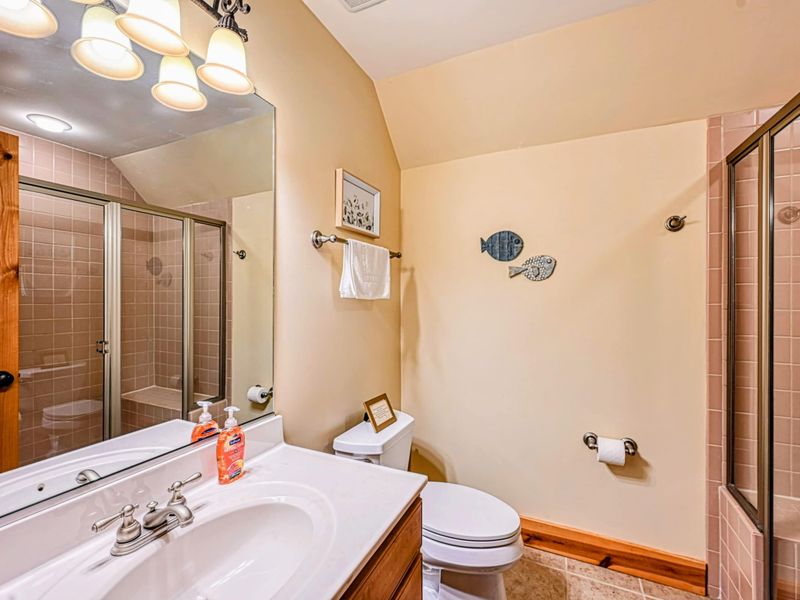 Refresh in this charming bathroom featuring a tiled glass shower and a clean, cozy atmosphere.