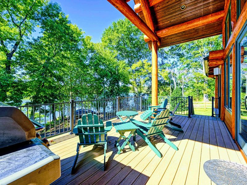 Exterior - Dramatic timber A-frame peaks and warm light from floor-to-ceiling windows welcome you at dusk.