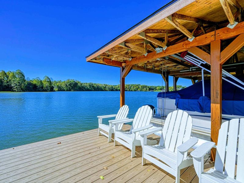 Dock - Adirondack chairs under the shade sail offer a front-row seat to the lake on a perfect bluebird day.