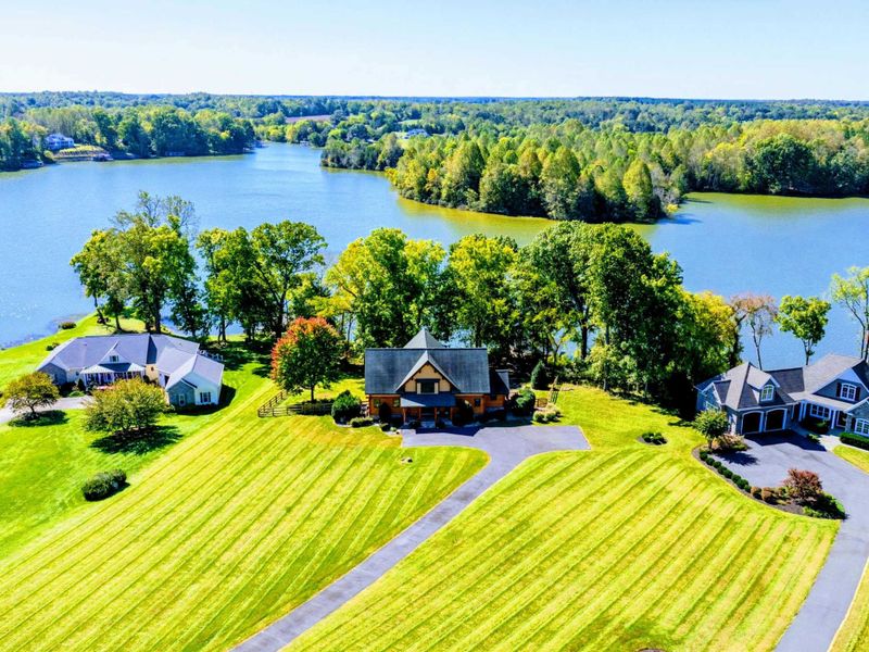 Beautiful lakeside property with expansive green lawns and serene waterfront views, perfect for a peaceful retreat