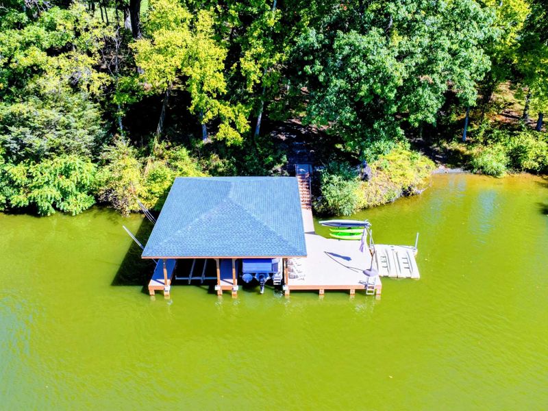 Relax at this private lakeside dock featuring a covered seating area, paddleboards, and easy access to the water for endless outdoor fun.