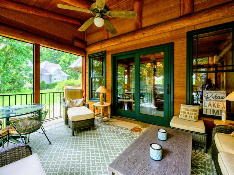 Exterior - Lake-side view reveals multiple levels, stone accents, timber framing, and decorative rock landscaping.