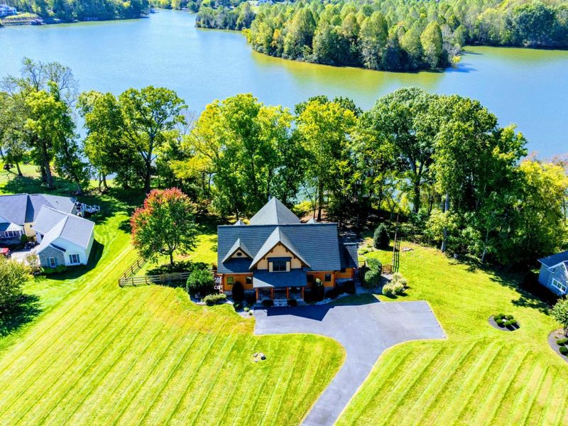 Enjoy a peaceful retreat at this stunning lakeside property, surrounded by lush greenery and expansive waterfront views.