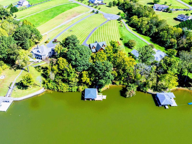 Experience the perfect lakefront getaway with private docks, lush tree-lined surroundings, and a serene neighborhood setting.