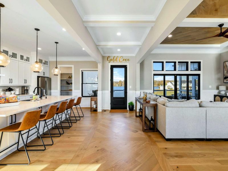 Kitchen - Open-concept kitchen with oversized island, bar seating, and pendant lights.