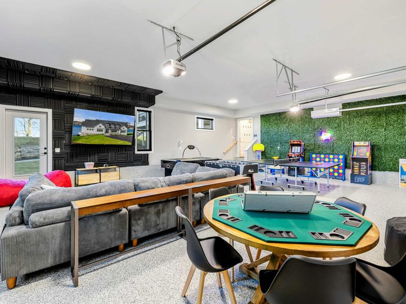 Game Room - Poker table, arcade cabinets, ping-pong, and foosball in the entertainment room.