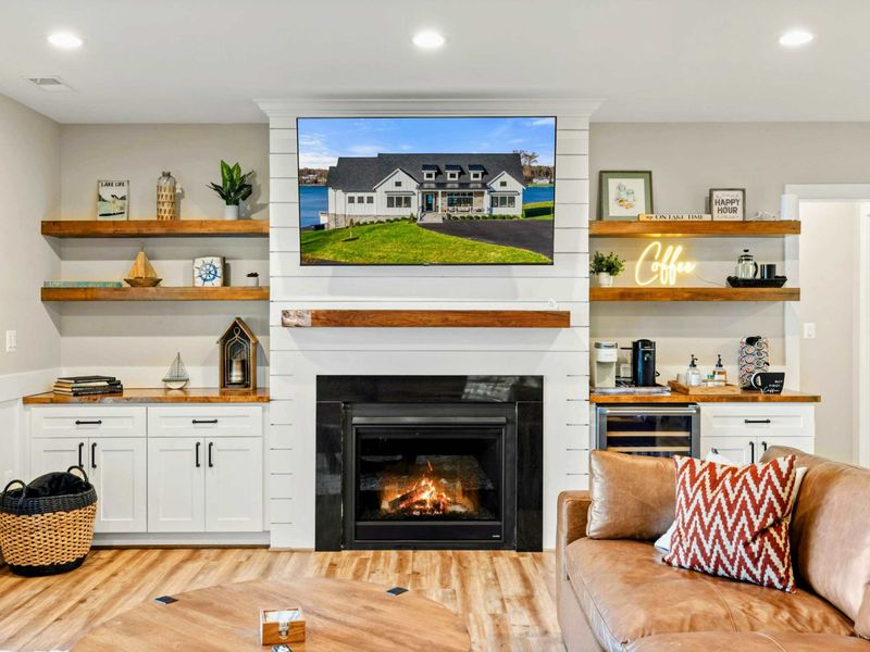 Lower Living Area - Built-in shelving, coffee station, and cozy fireplace corner.