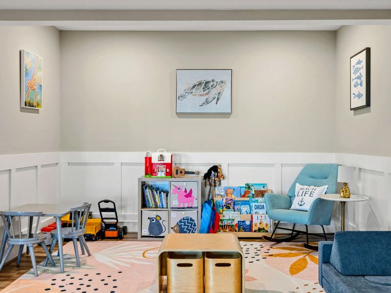 Lower Living Area - Kids' play area with a cozy reading nook, toys, and colorful decor.