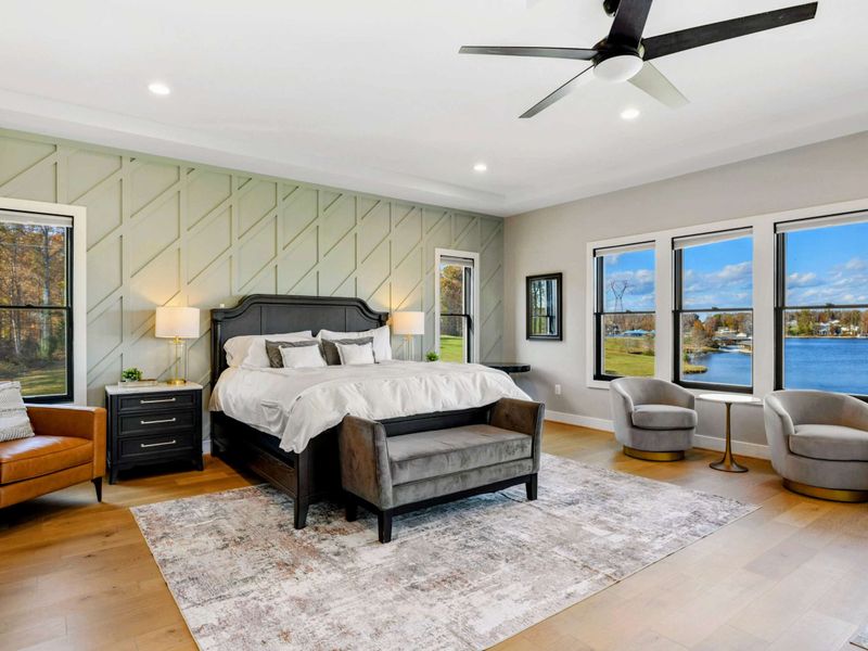 Primary Suite - View from the bed toward the sitting area and lakeside windows.