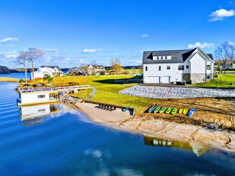 Beach - Sandy beach with sun loungers, kayaks, and a gentle slope to the water.