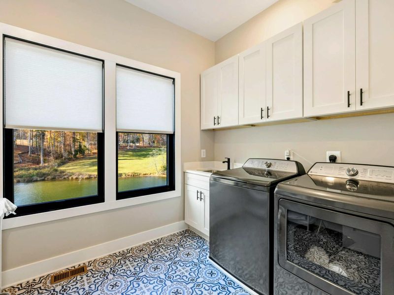 Laundry Room - Lower level laundry with front-load machines, folding area, and a window view.