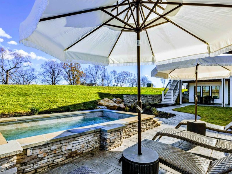 Backyard - Spa, firepit, and lounge chairs overlooking the lake and dock.