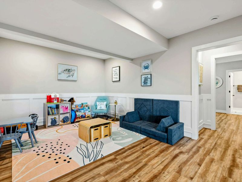 Lower Living Area - Detail of the play corner with storage bins and soft seating.