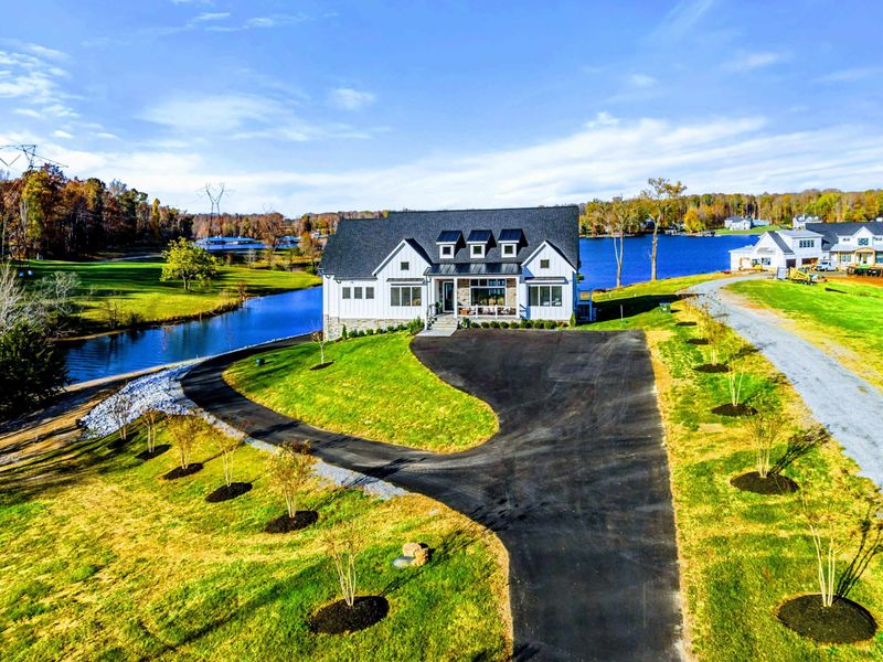 Exterior - Entry drive with stone landscaping and the front of the home.