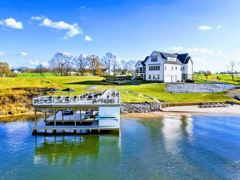 Exterior - Wide-angle view of the property from the lake showing the full waterfront layout.