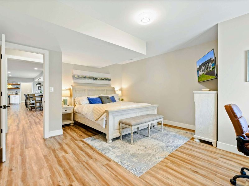 Bedroom 2 - King bed, work desk, and en-suite bath access with neutral decor.