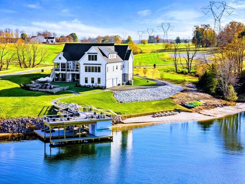 Dock - Two-level dock with covered seating, lounge chairs, and direct water access.