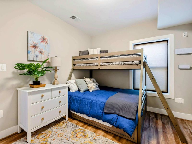 Bunk Room (Small) - Twin-over-twin bunks, accent wall, and built-in desk.