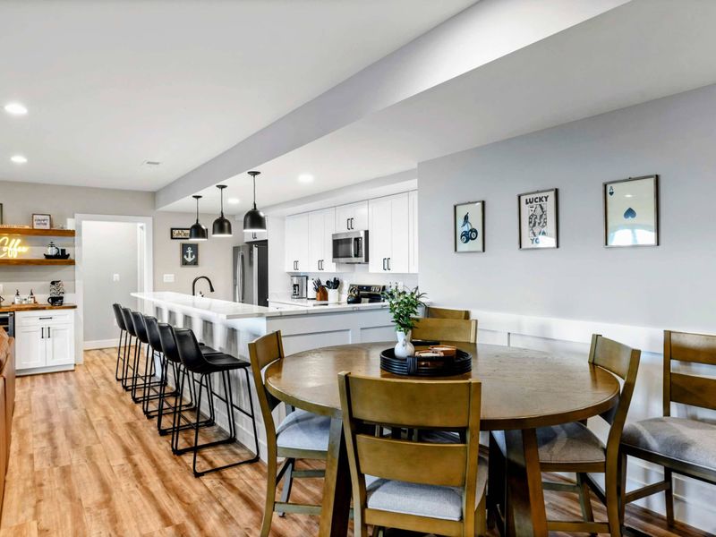 Lower Living Area - Full lower level with seating, kitchenette, and patio access visible.