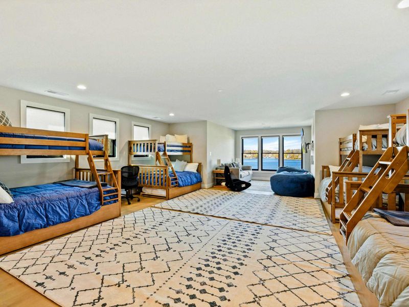 Bunk Room (Large) - Four sets of bunks, a daybed, and open floor space.