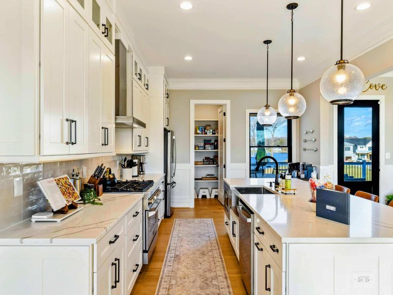 Kitchen - Detail of the gas range and tiled backsplash.