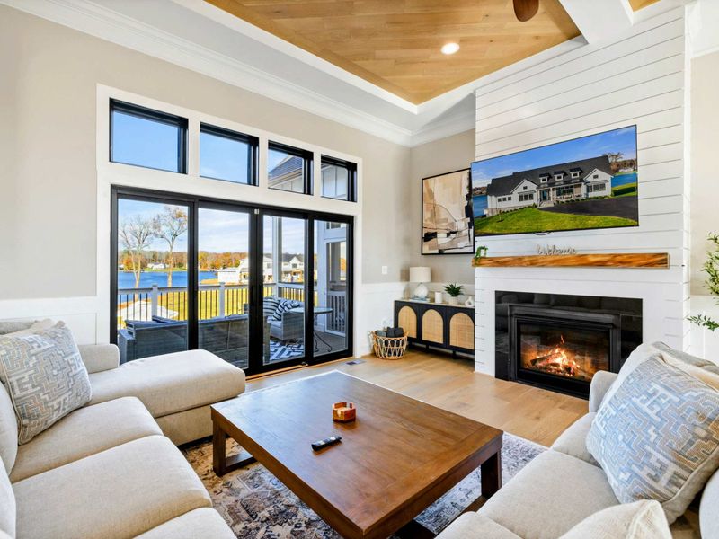 Great Room - Fireplace, comfortable seating, and glass doors opening to the lake.