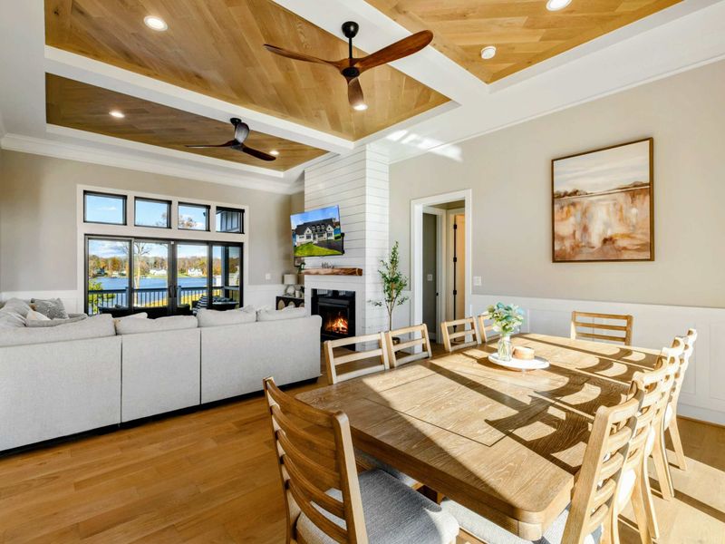 Great Room - Living and dining area with fireplace, built-in shelves, and large windows.