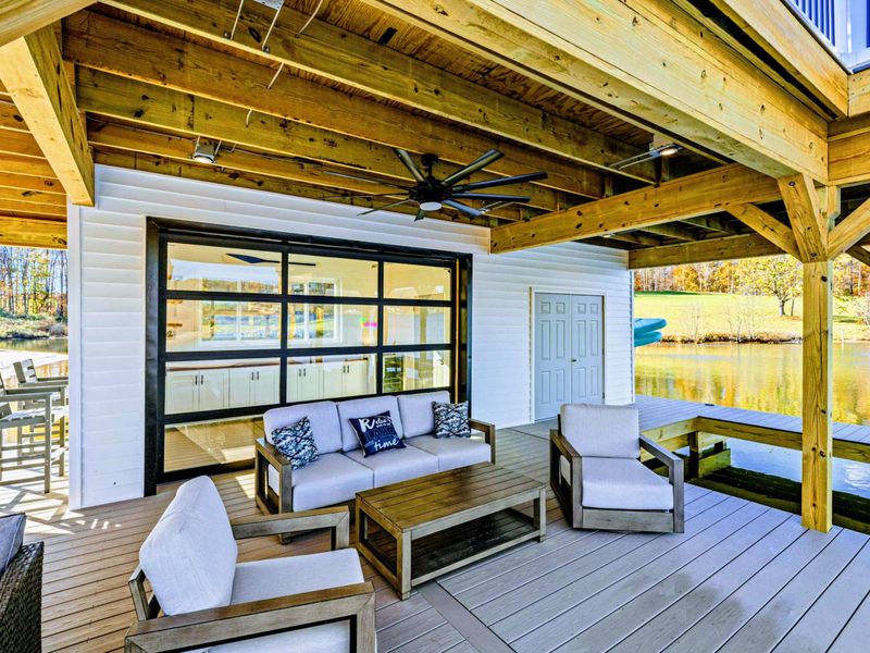 Dock - Waterfront lounge with roll-up bar window and built-in seating.