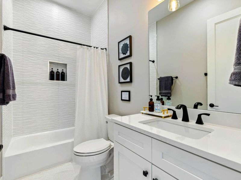 Bathroom 3 - Shared bath with modern vanity, tiled shower-tub combo, and clean finishes.