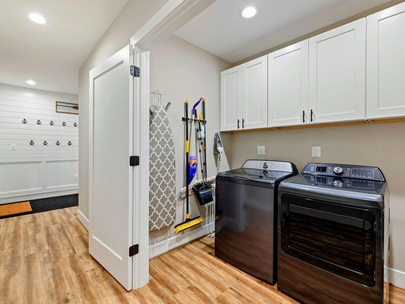 Laundry Room - Full-size washer and dryer with folding counter and mudroom storage.