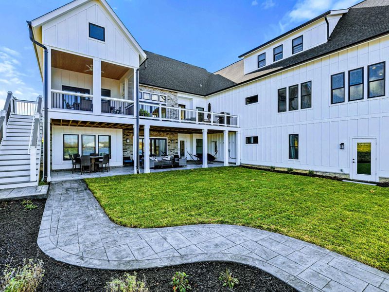 Backyard - Manicured lawn leading from the covered patio to the upper deck.