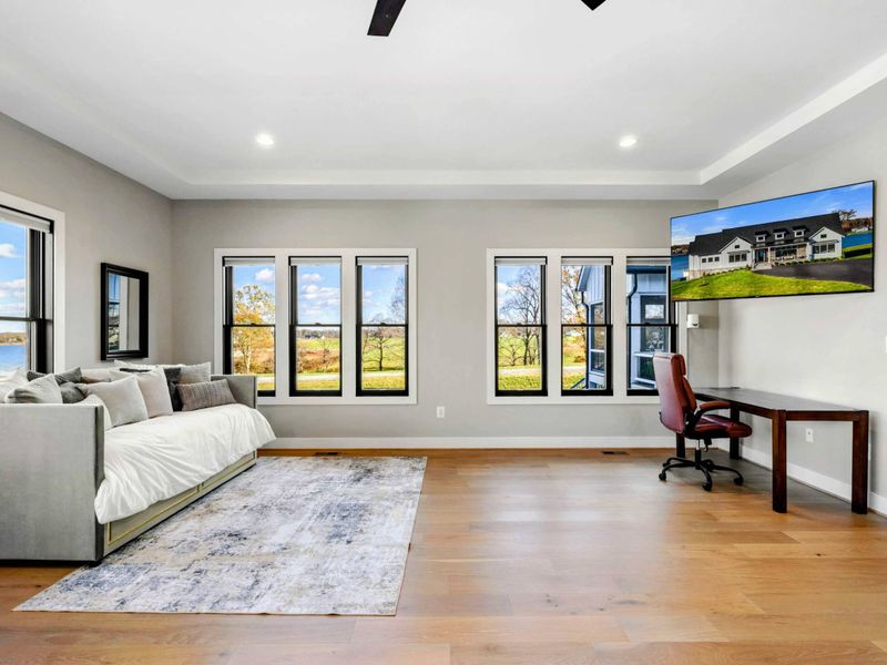 Primary Suite - Wide shot showing the full suite layout with en-suite bath entry visible.