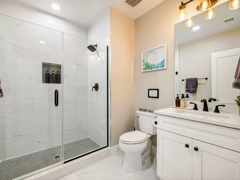 Bathroom 5 - Alternate angle showing the shower and vanity arrangement.