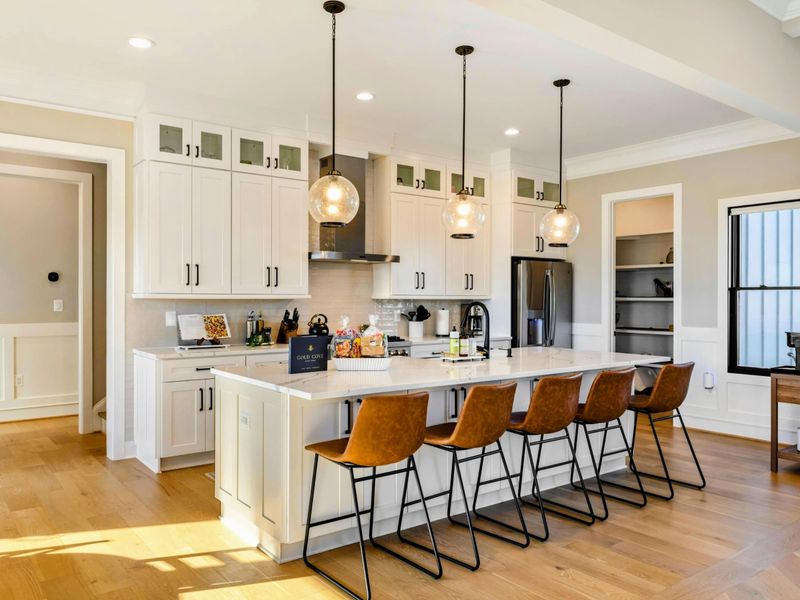 Kitchen - Full kitchen view with island, stainless appliances, and lake-view windows.