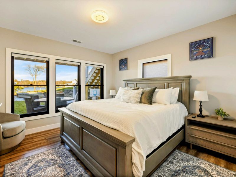 Bedroom 7 - Bedside detail with reading lamp and nightstand.