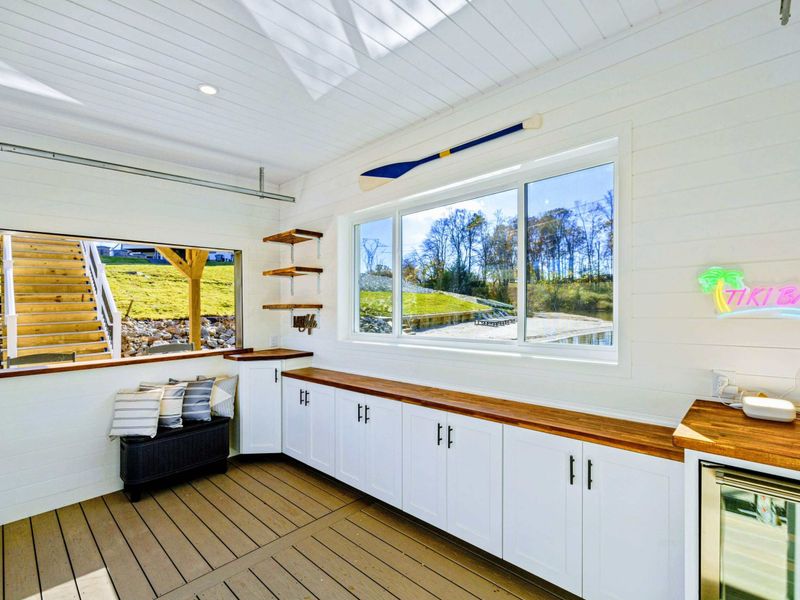 Boathouse - Interior bar area with countertop seating and views through oversized windows.
