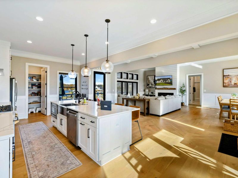 Kitchen - Bright island workspace with pendant lighting and open flow to the living area.