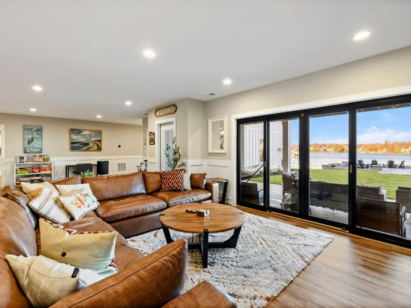 Lower Living Area - Alternate angle of the sectional seating with lake light filtering in.