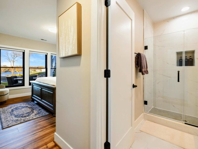 Bathroom 5 - Glass-enclosed shower with elegant tile, modern vanity, and bright finishes.